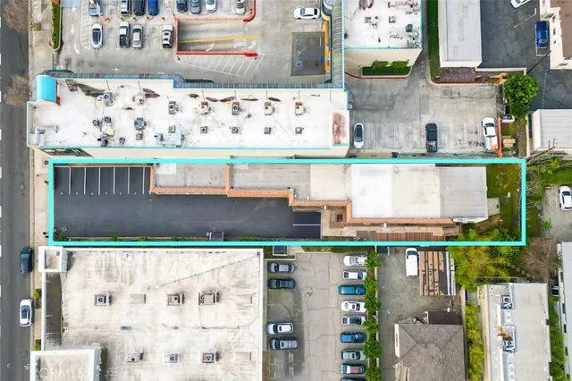 an aerial view of a house with a large pool