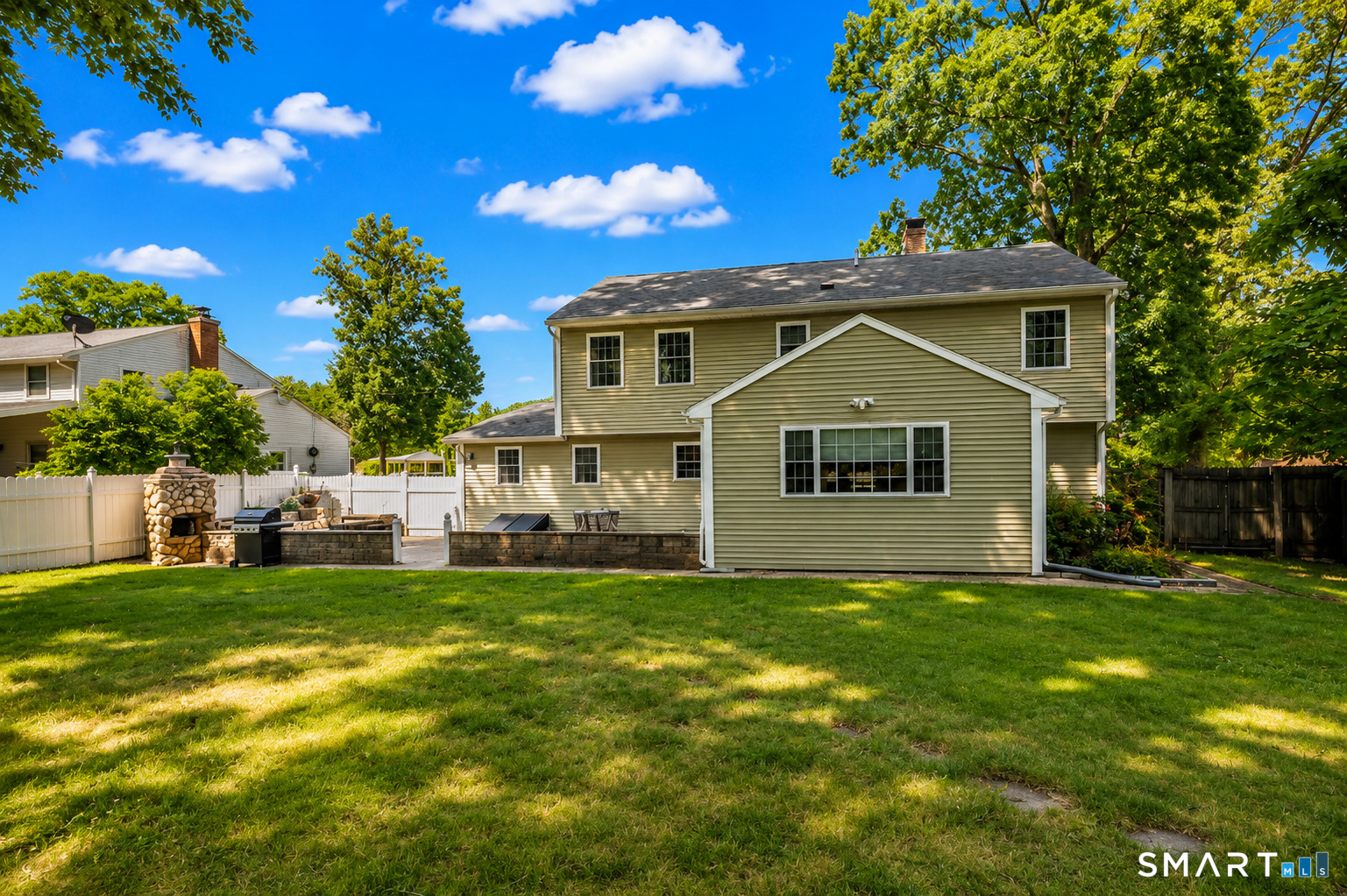 144 Goff Road Wethersfield, CT 06109 - Photo 23 of 26 A spacious, tree-lined backyard offers plenty of room to relax, play and entertain, with easy access to the impressive outdoor living spaces.