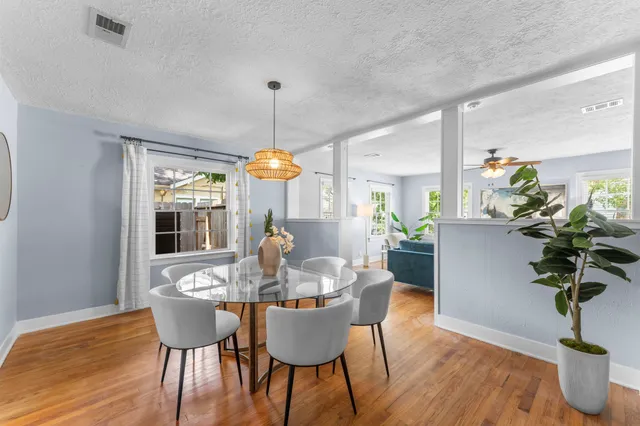 a view of a dining room with furniture window and wooden floor
