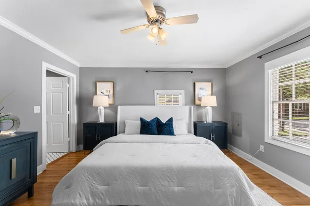 a bedroom with a bed and a chandelier