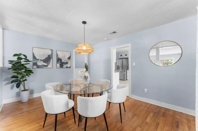 a view of a dining room with furniture and wooden floor