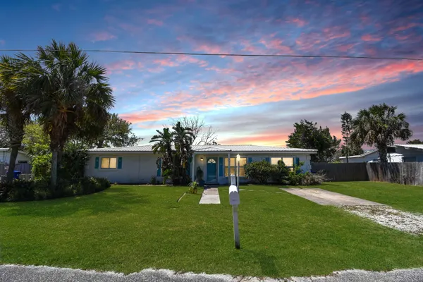 a view of house with a yard