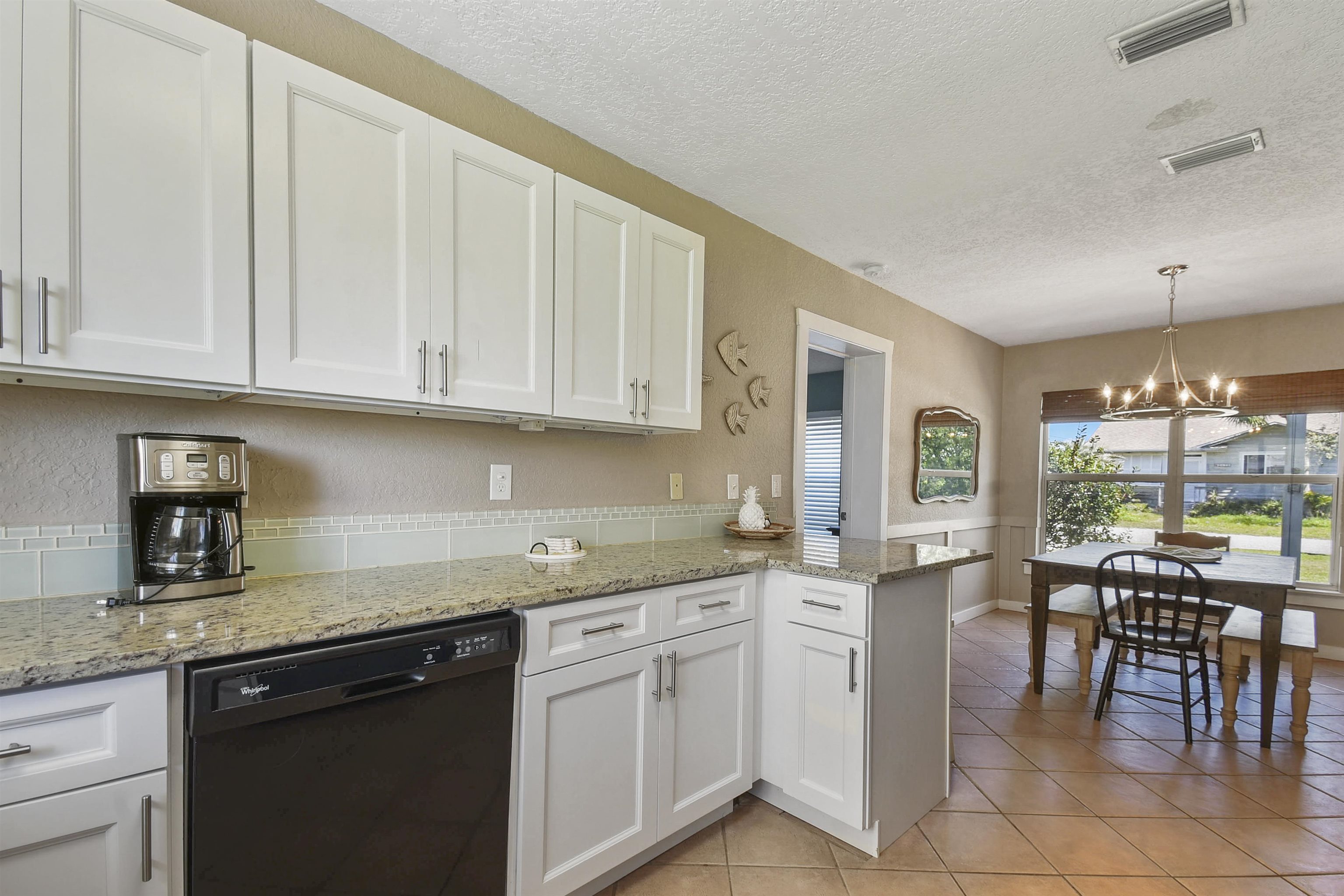 5479 2nd Street St. Augustine, FL 32080 - Photo 11 of 31 a kitchen with granite countertop white cabinets and white appliances