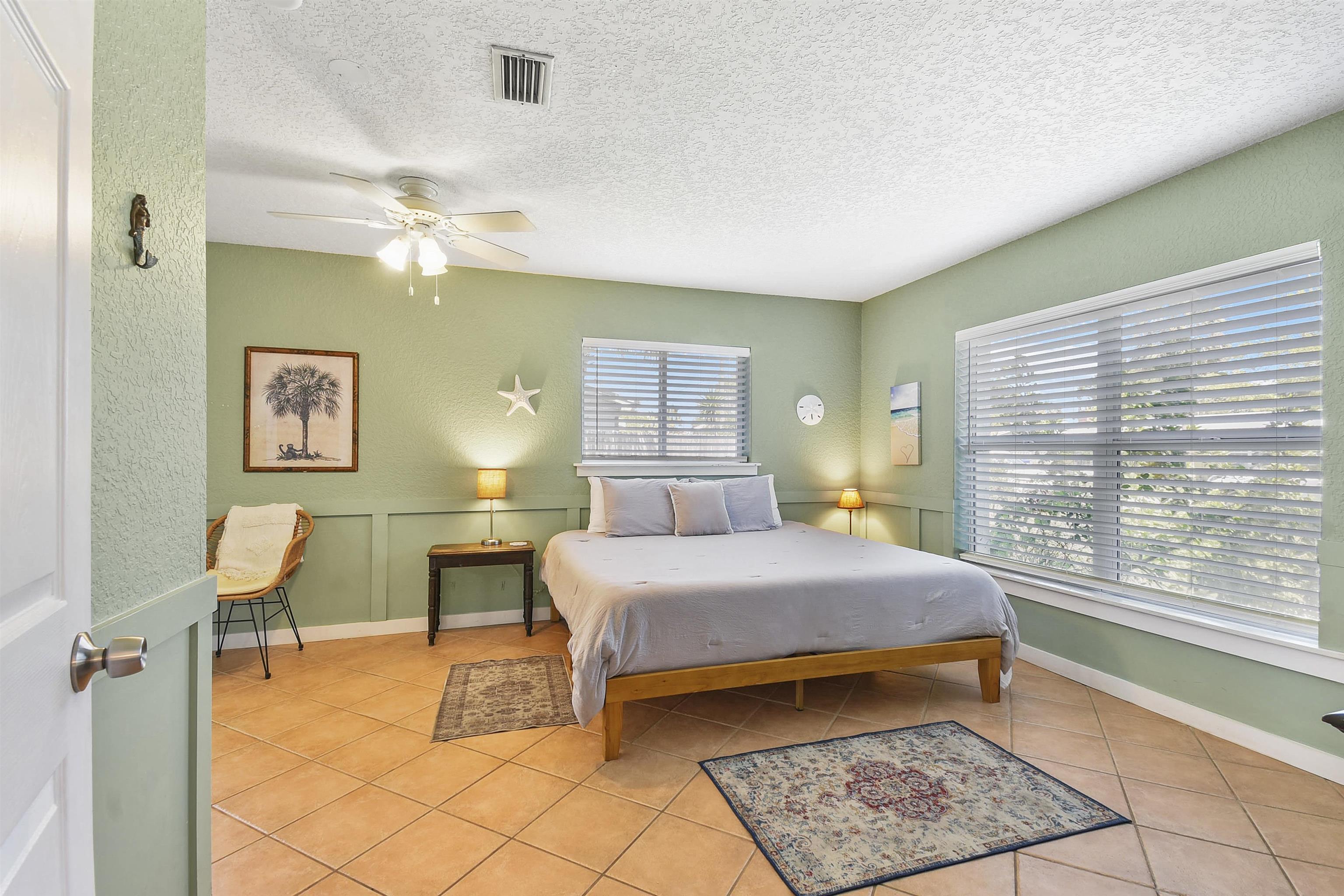 5479 2nd Street St. Augustine, FL 32080 - Photo 12 of 31 a bedroom with a bed lamps and window