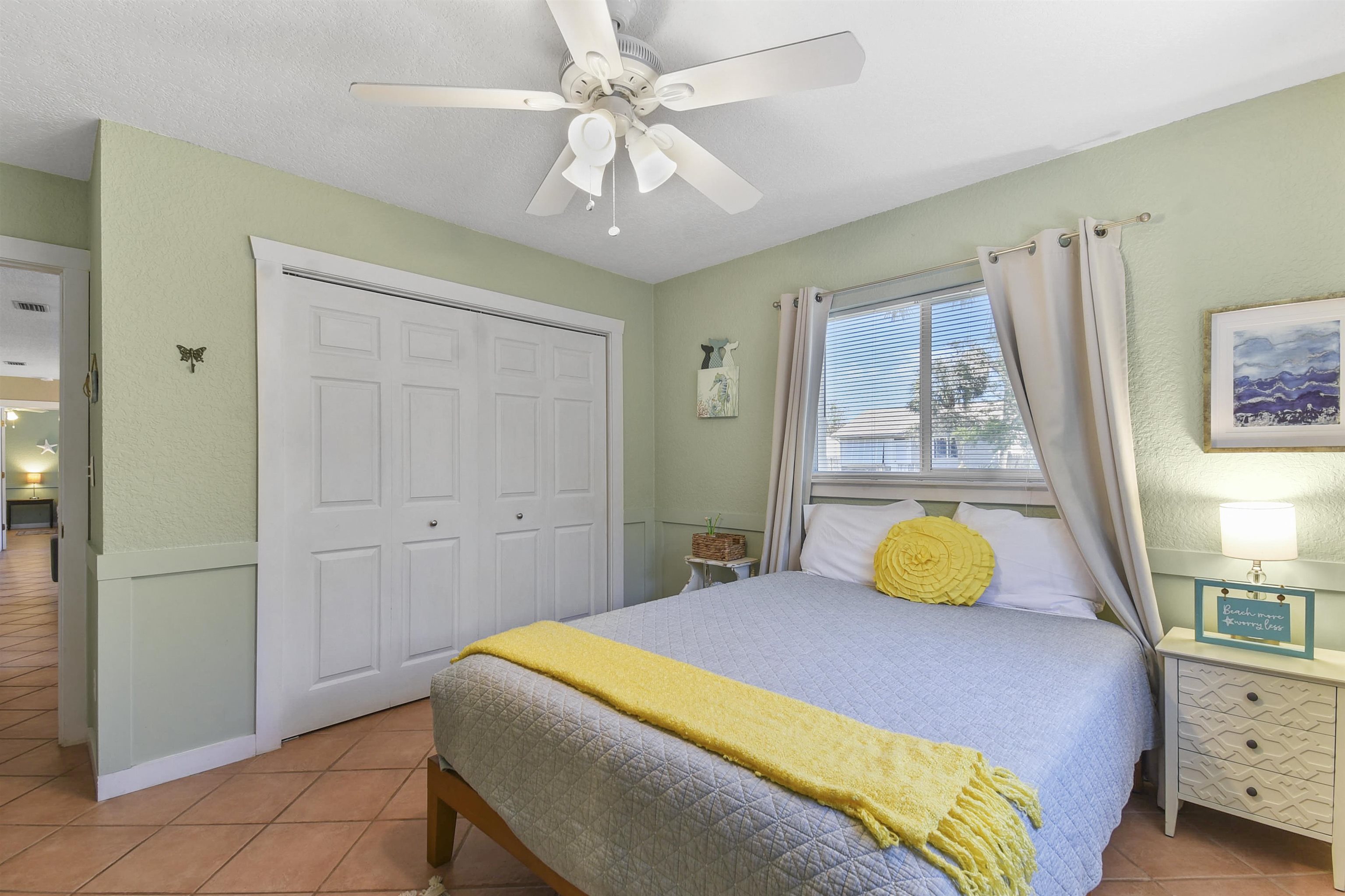 5479 2nd Street St. Augustine, FL 32080 - Photo 18 of 31 a bedroom with a bed and a chandelier