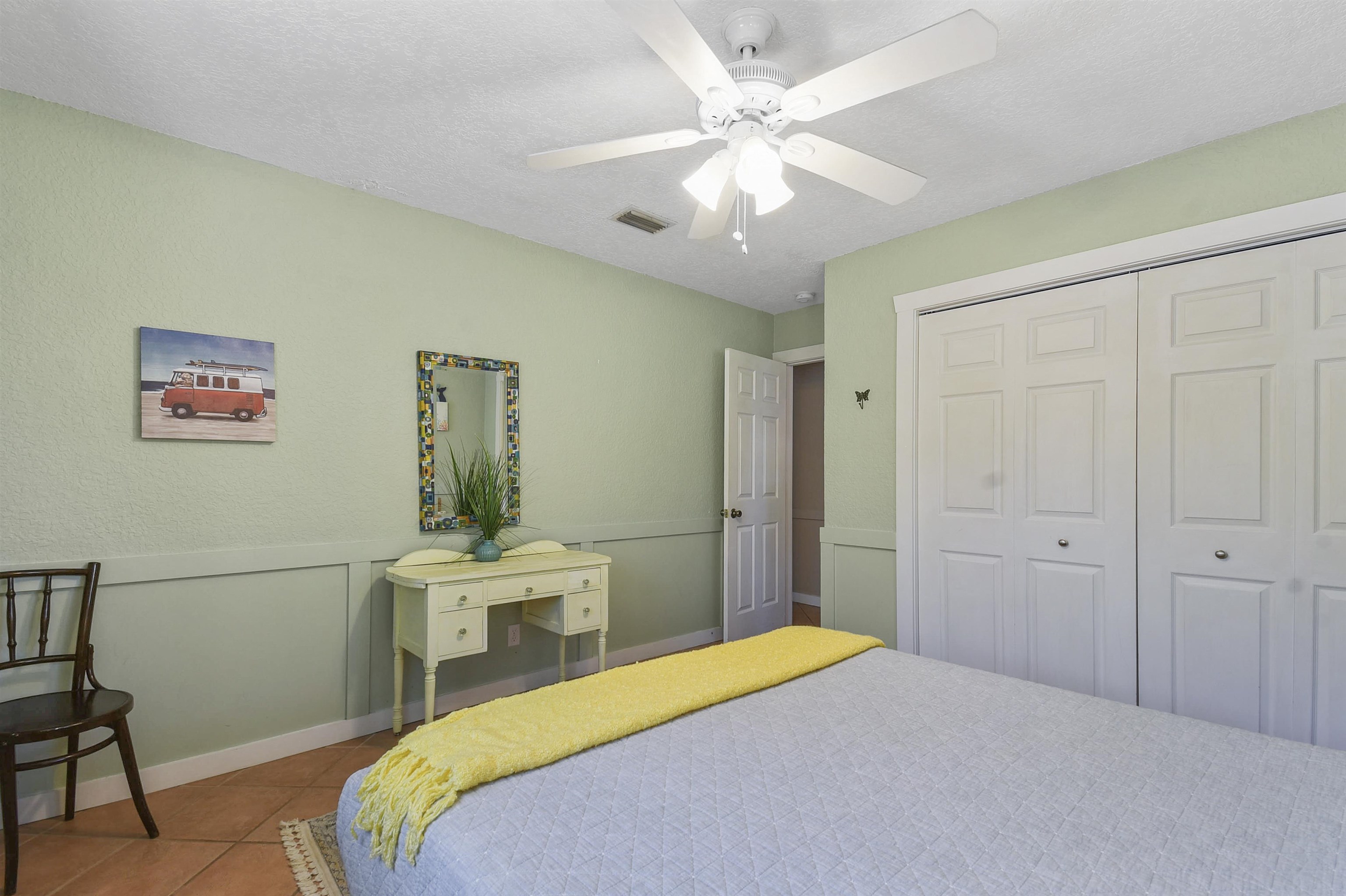 5479 2nd Street St. Augustine, FL 32080 - Photo 19 of 31 a bedroom with a bed and a chandelier