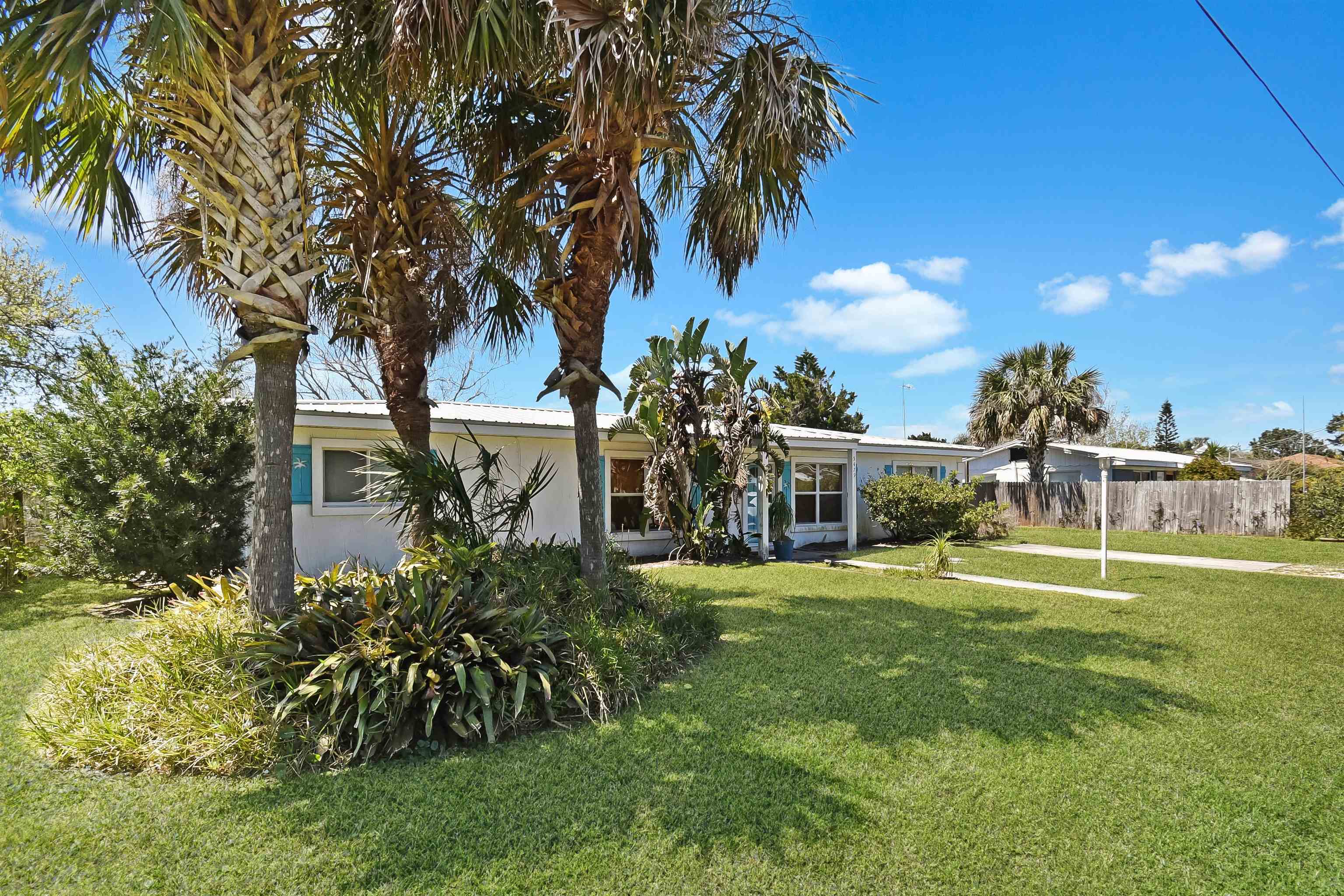 5479 2nd Street St. Augustine, FL 32080 - Photo 2 of 31 a view of a house with a yard and palm trees