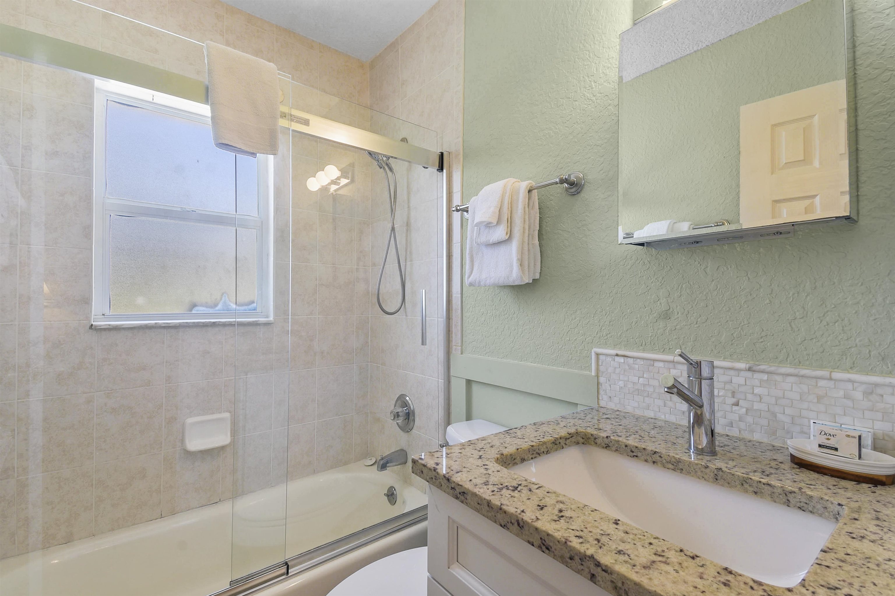 5479 2nd Street St. Augustine, FL 32080 - Photo 23 of 31 a bathroom with a granite countertop sink mirror and vanity