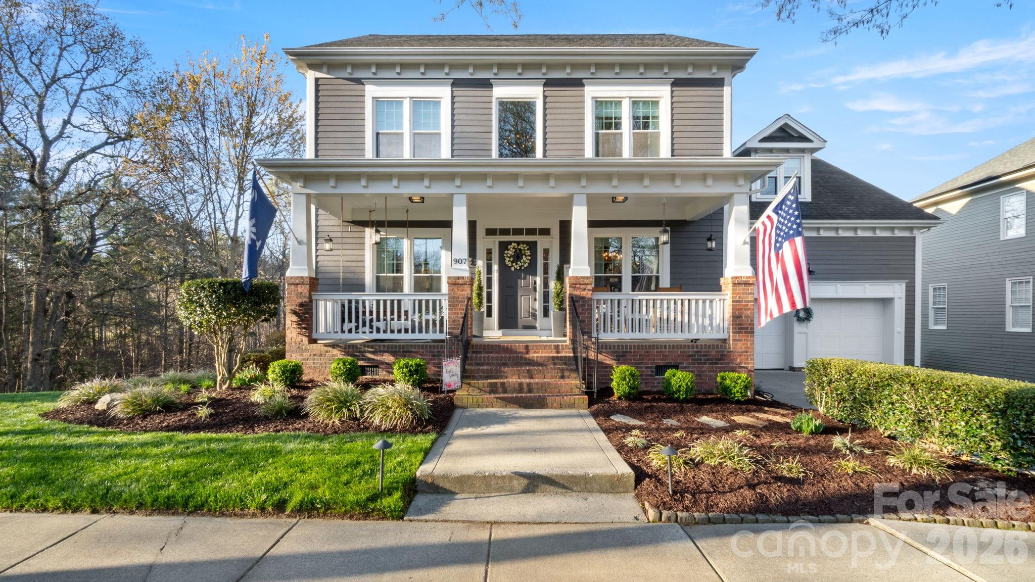907 Derick's Crossing Fort Mill, SC 29708 - Photo 1 of 47 a front view of a house with a garden