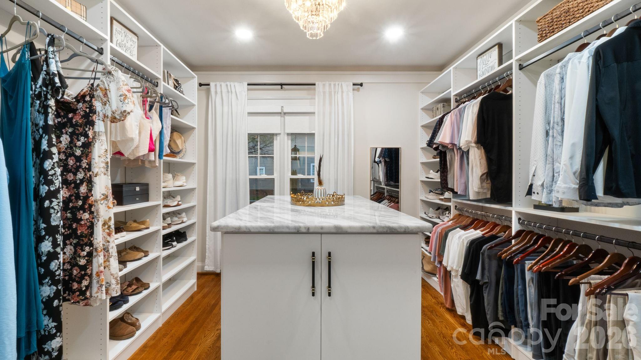 907 Derick's Crossing Fort Mill, SC 29708 - Photo 17 of 47 a view of walk in closet with clothes and shoes