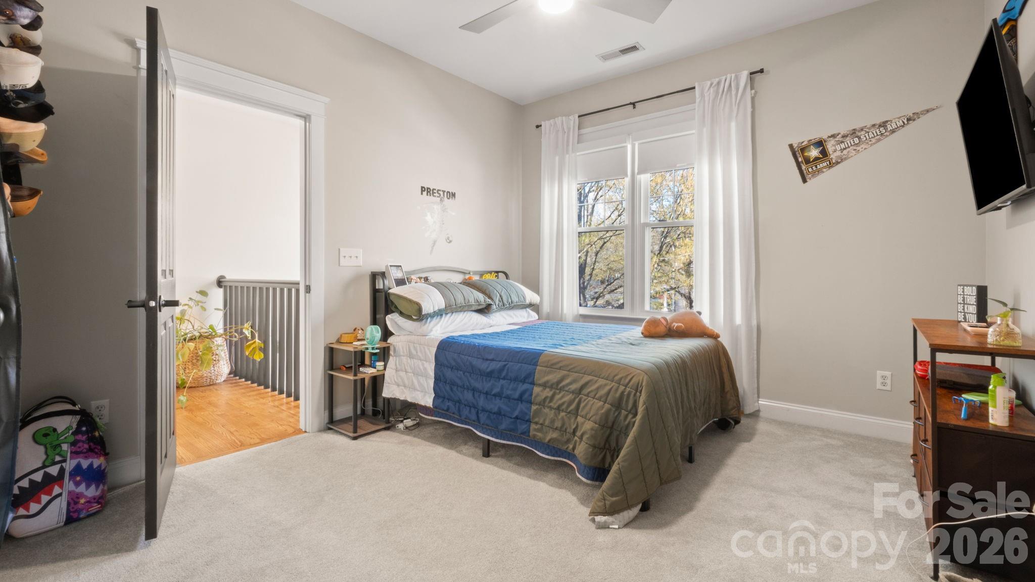 907 Derick's Crossing Fort Mill, SC 29708 - Photo 23 of 47 a bedroom with a bed a flat screen tv and a window