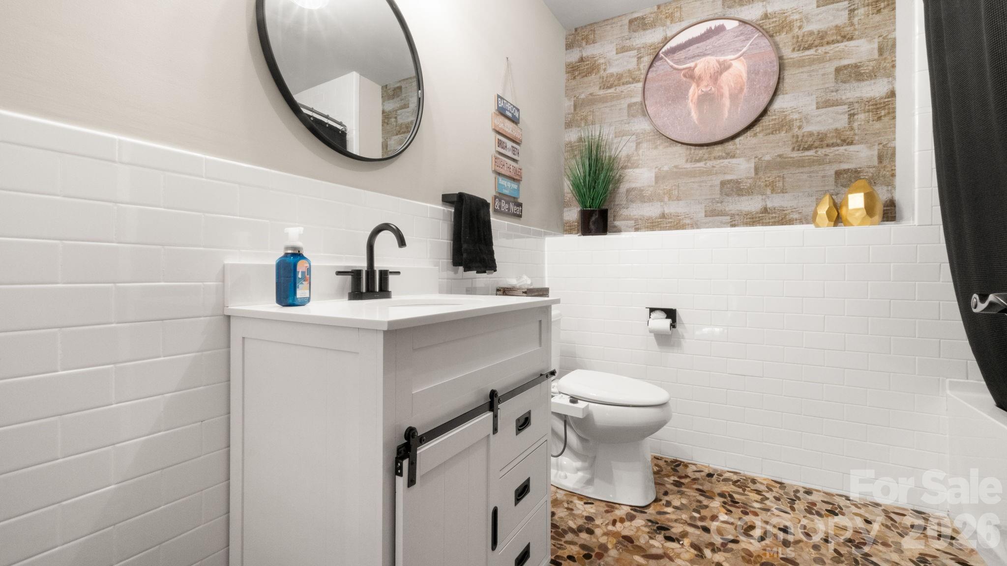 907 Derick's Crossing Fort Mill, SC 29708 - Photo 27 of 47 a bathroom with a toilet sink vanity and mirror