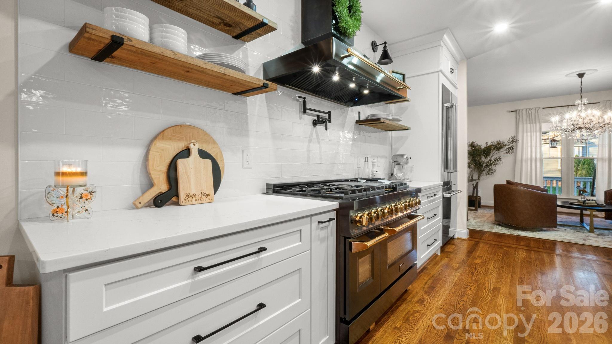 907 Derick's Crossing Fort Mill, SC 29708 - Photo 8 of 47 a kitchen with a stove and a wooden floor