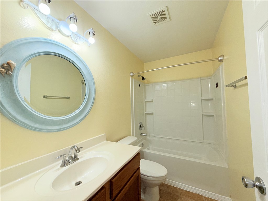 1019 Livermore Street Portland, TX 78374 - Photo 13 of 32 a bathroom with a sink a toilet and shower