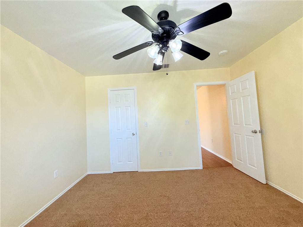 1019 Livermore Street Portland, TX 78374 - Photo 17 of 32 an empty room with a ceiling fan and a window