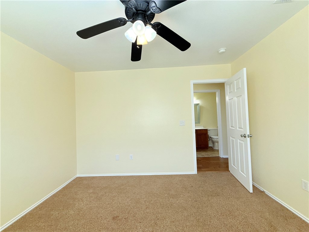 1019 Livermore Street Portland, TX 78374 - Photo 23 of 32 an empty room and chandelier fan