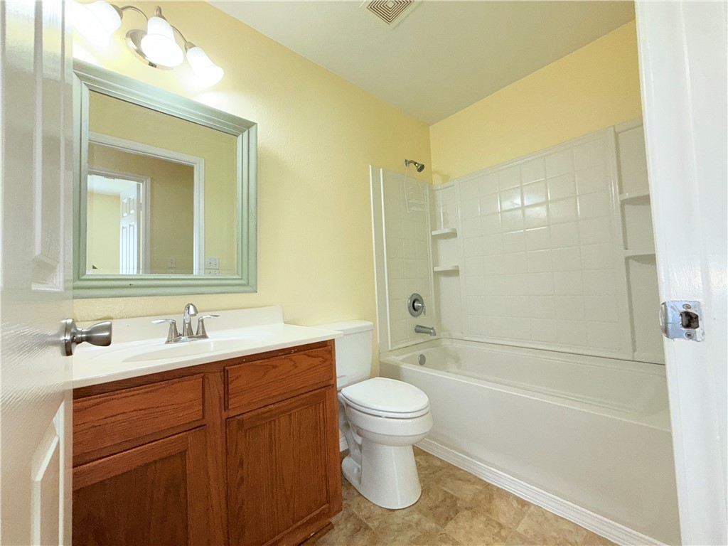 1019 Livermore Street Portland, TX 78374 - Photo 26 of 32 a bathroom with a sink a toilet and shower