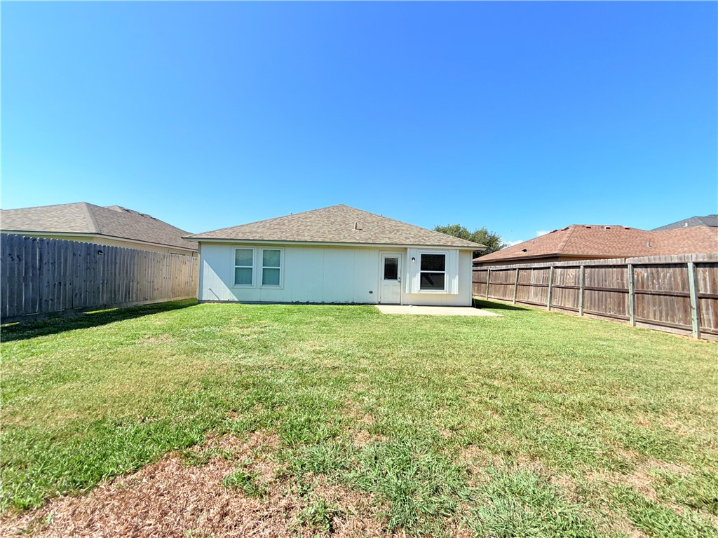 1019 Livermore Street Portland, TX 78374 - Photo 31 of 32 a view of a yard in front of a house with a large tree