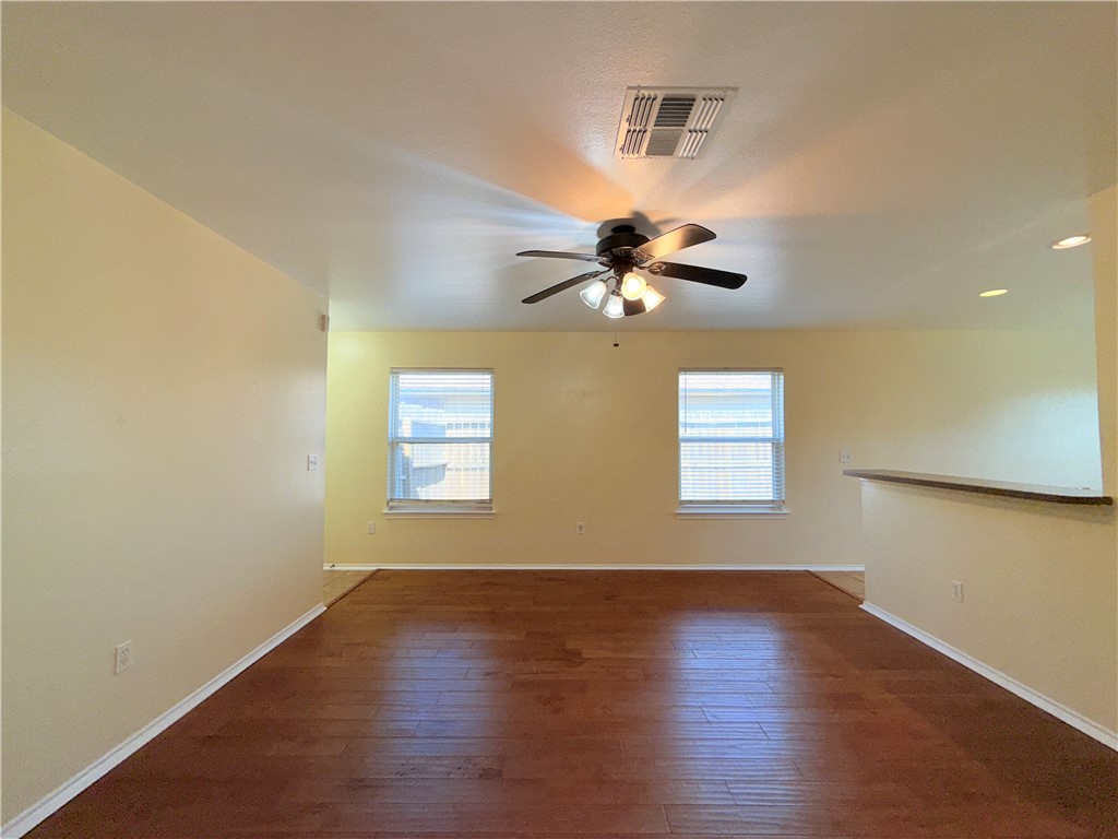 1019 Livermore Street Portland, TX 78374 - Photo 4 of 32 a view of an empty room with wooden floor and a window