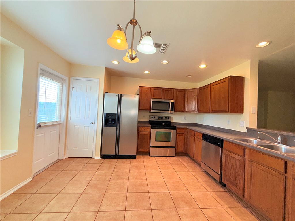 1019 Livermore Street Portland, TX 78374 - Photo 5 of 32 a large kitchen with a large counter space stainless steel appliances and cabinets
