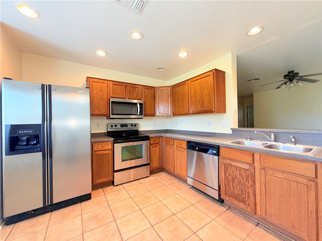 1019 Livermore Street Portland, TX 78374 - Photo 8 of 32 a kitchen with stainless steel appliances granite countertop a refrigerator and a stove top oven
