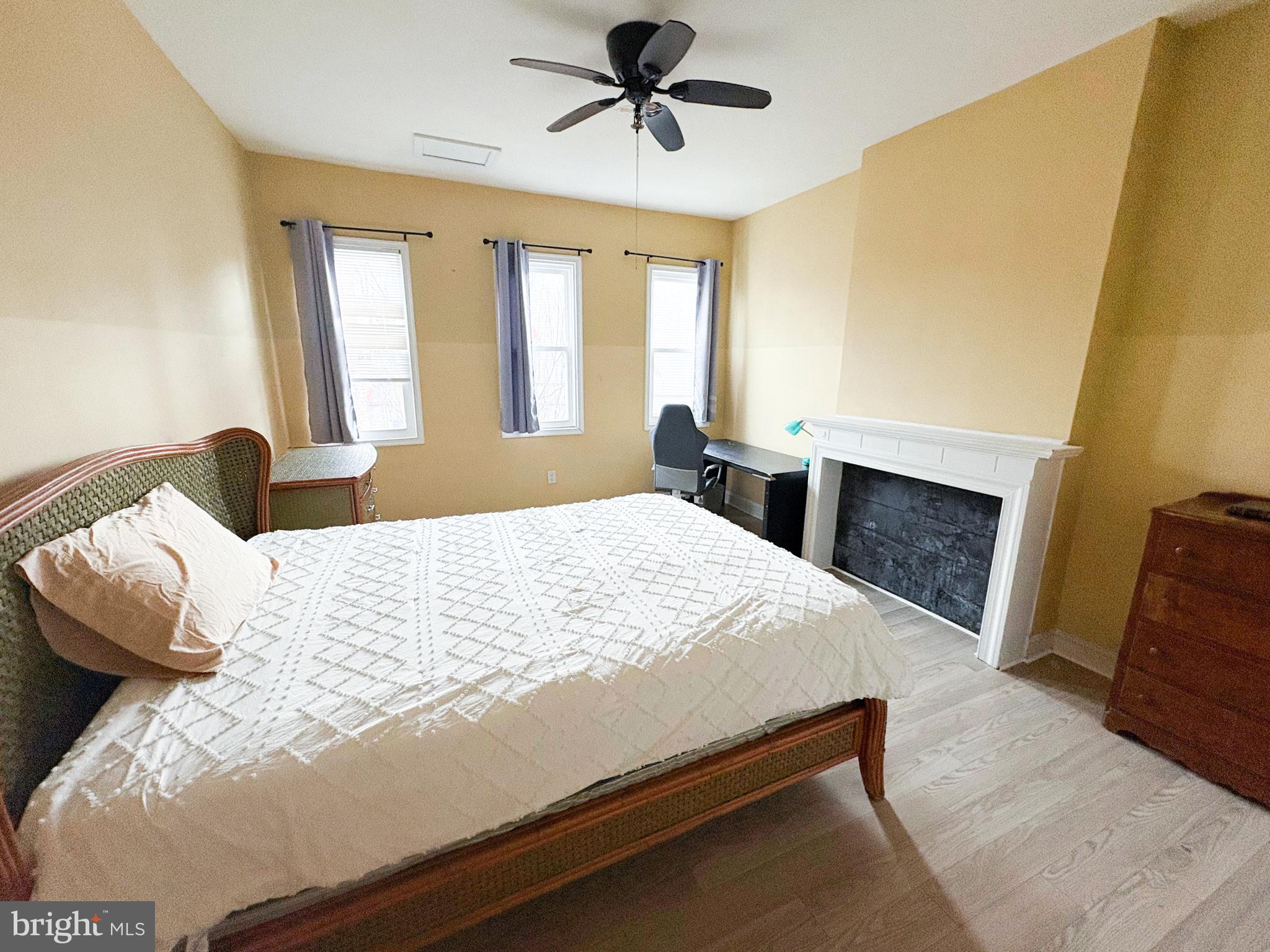 754 Dolphin Street Baltimore, MD 21217 - Photo 11 of 23 a bedroom with a bed and a fireplace