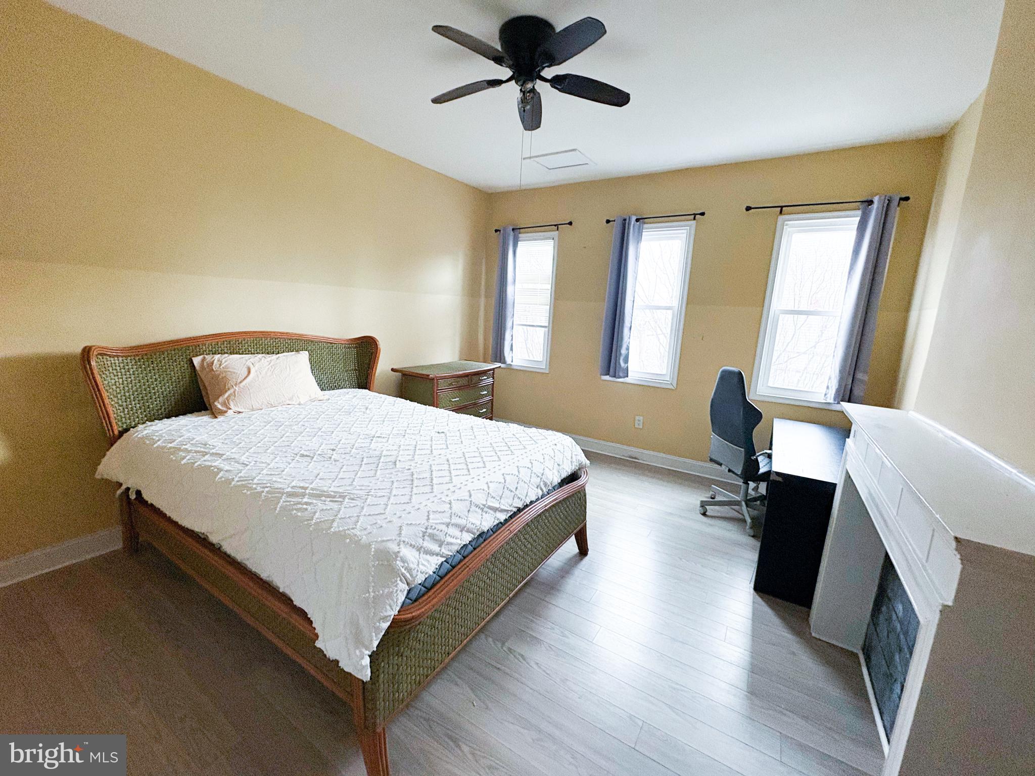 754 Dolphin Street Baltimore, MD 21217 - Photo 12 of 23 a bedroom with a bed and wooden floor