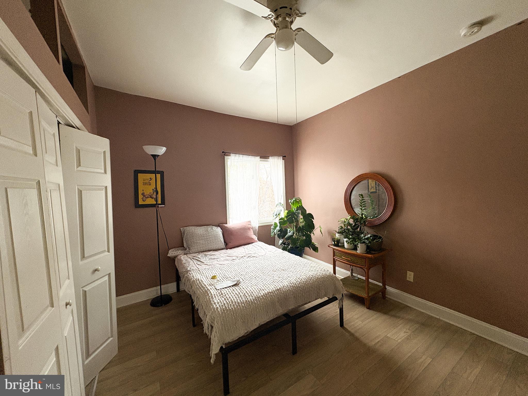 754 Dolphin Street Baltimore, MD 21217 - Photo 14 of 23 a view of a room that has a bed and a chandelier