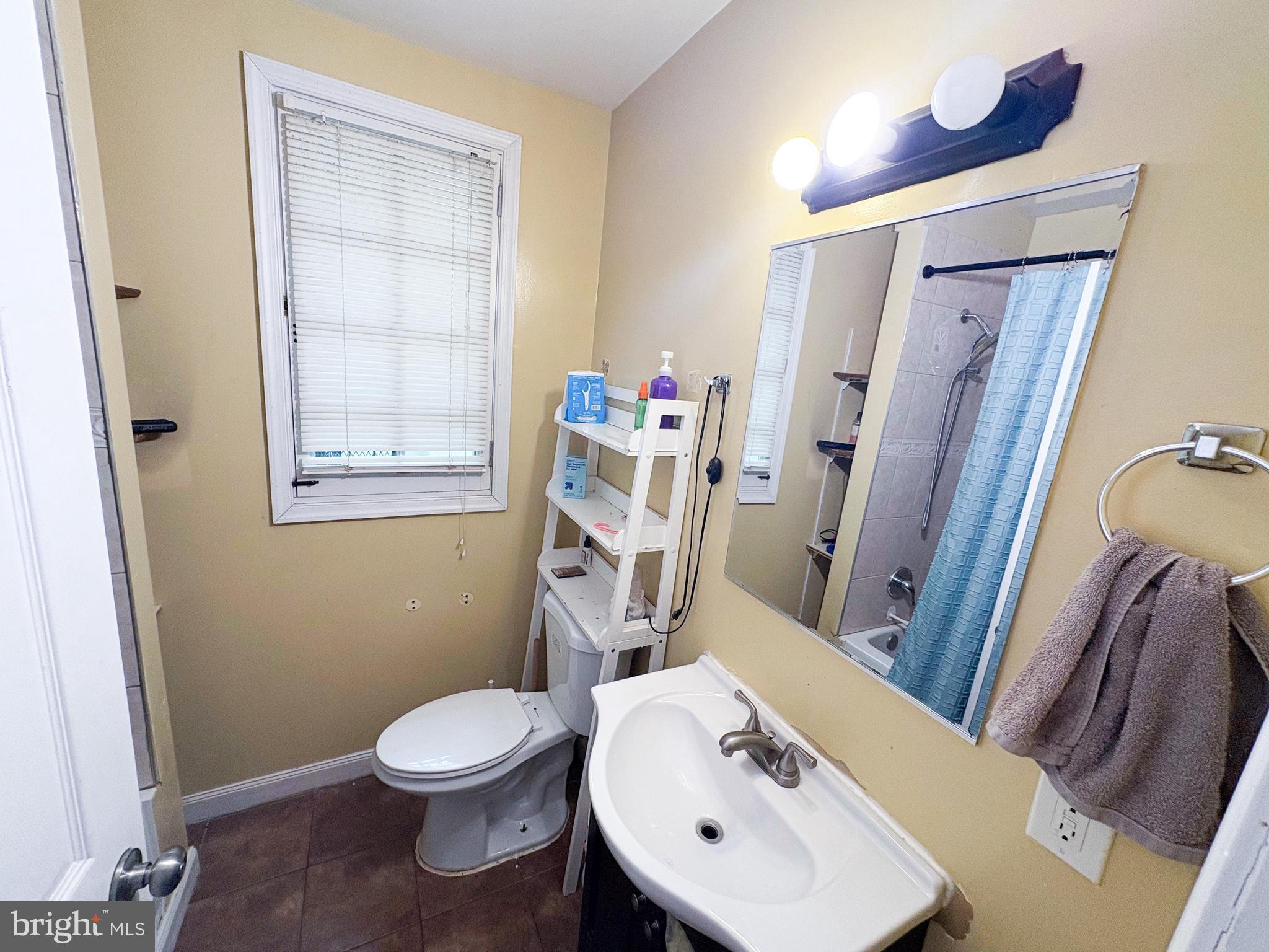 754 Dolphin Street Baltimore, MD 21217 - Photo 15 of 23 a bathroom with a sink a toilet and shower