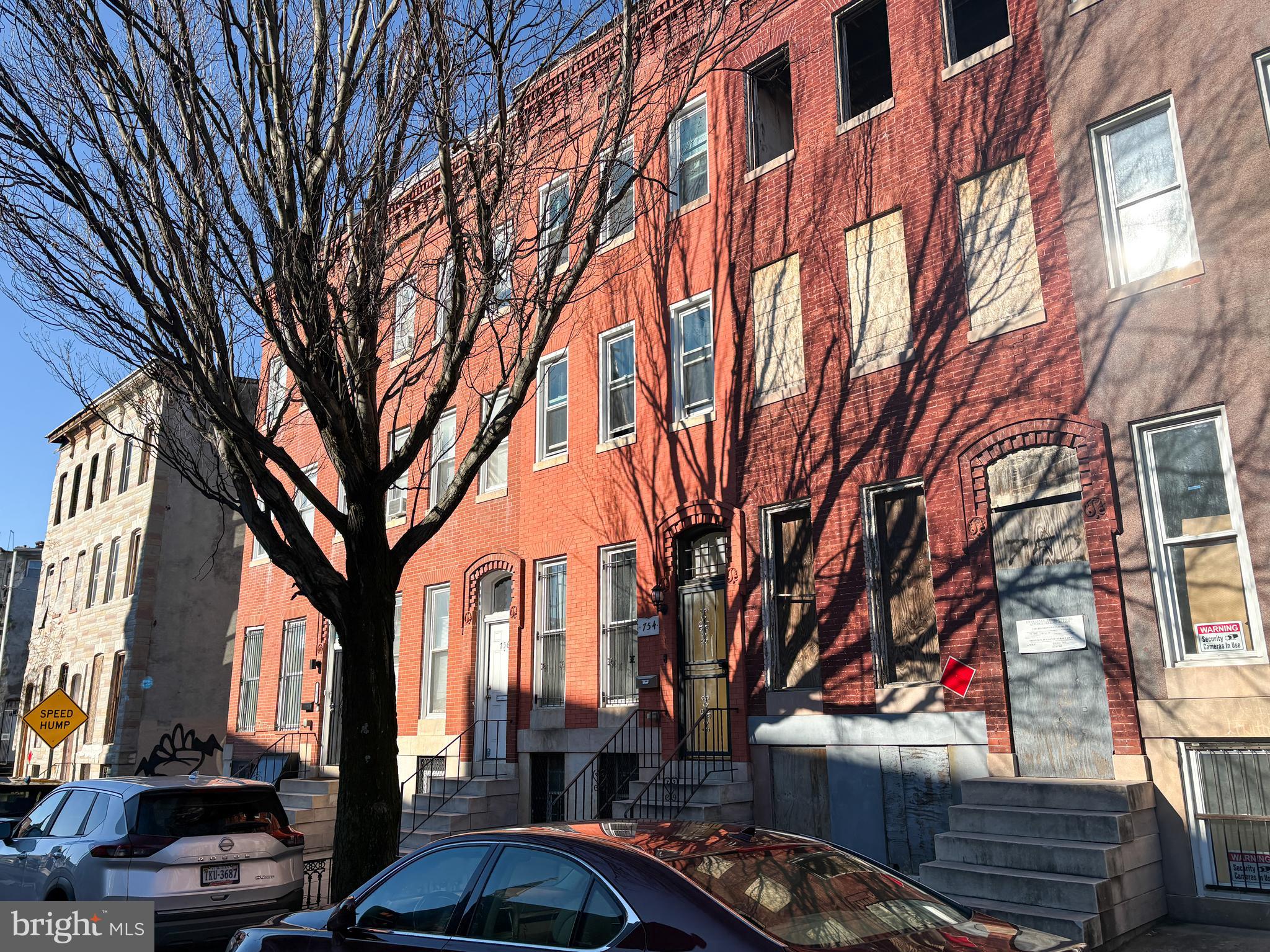 754 Dolphin Street Baltimore, MD 21217 - Photo 2 of 23 a city street lined with buildings and trees