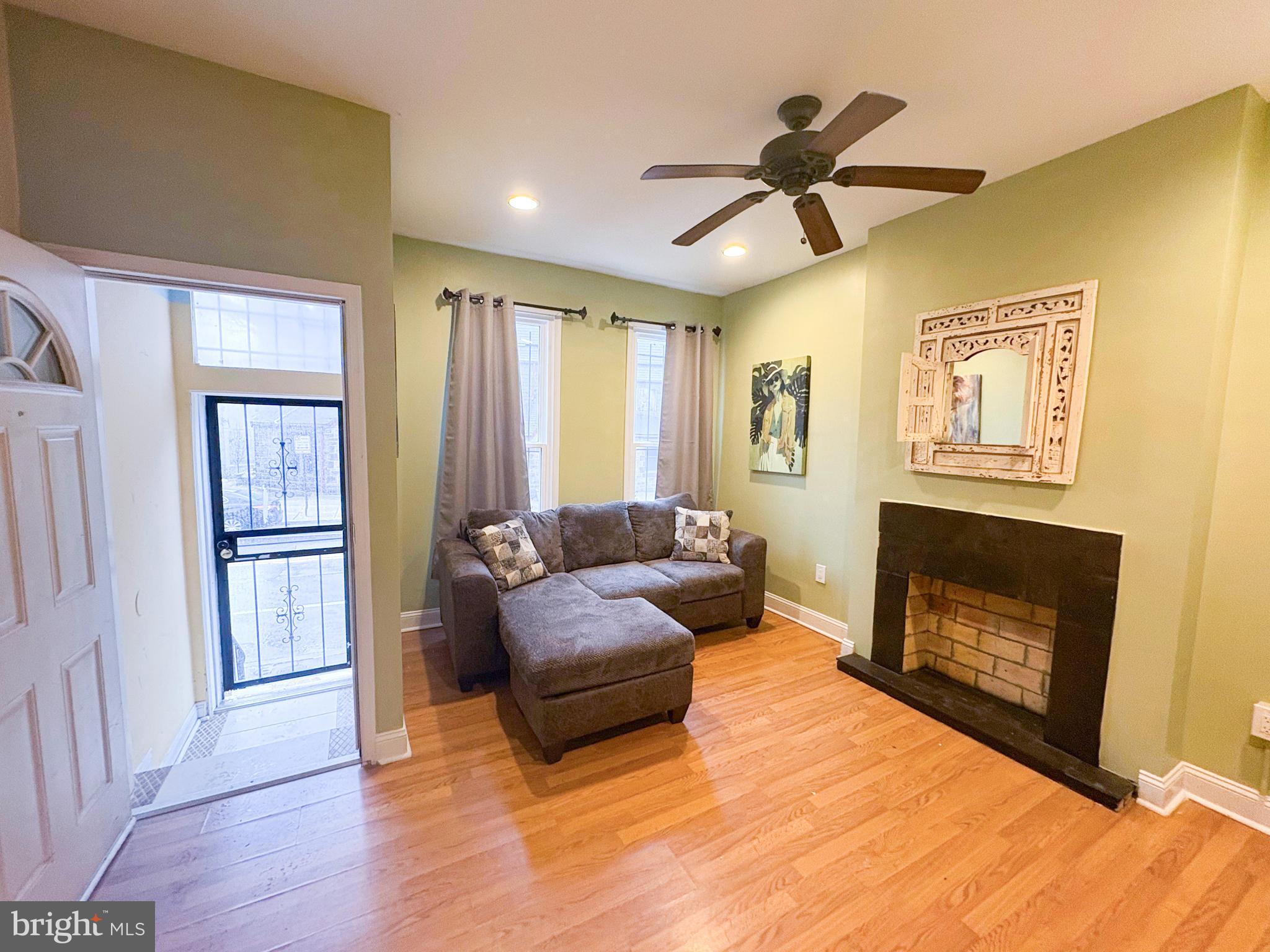754 Dolphin Street Baltimore, MD 21217 - Photo 3 of 23 a living room with furniture and a fireplace