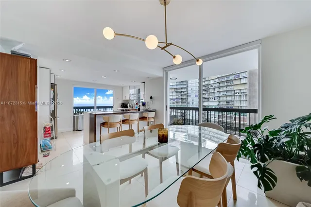 a kitchen with a refrigerator and white cabinets