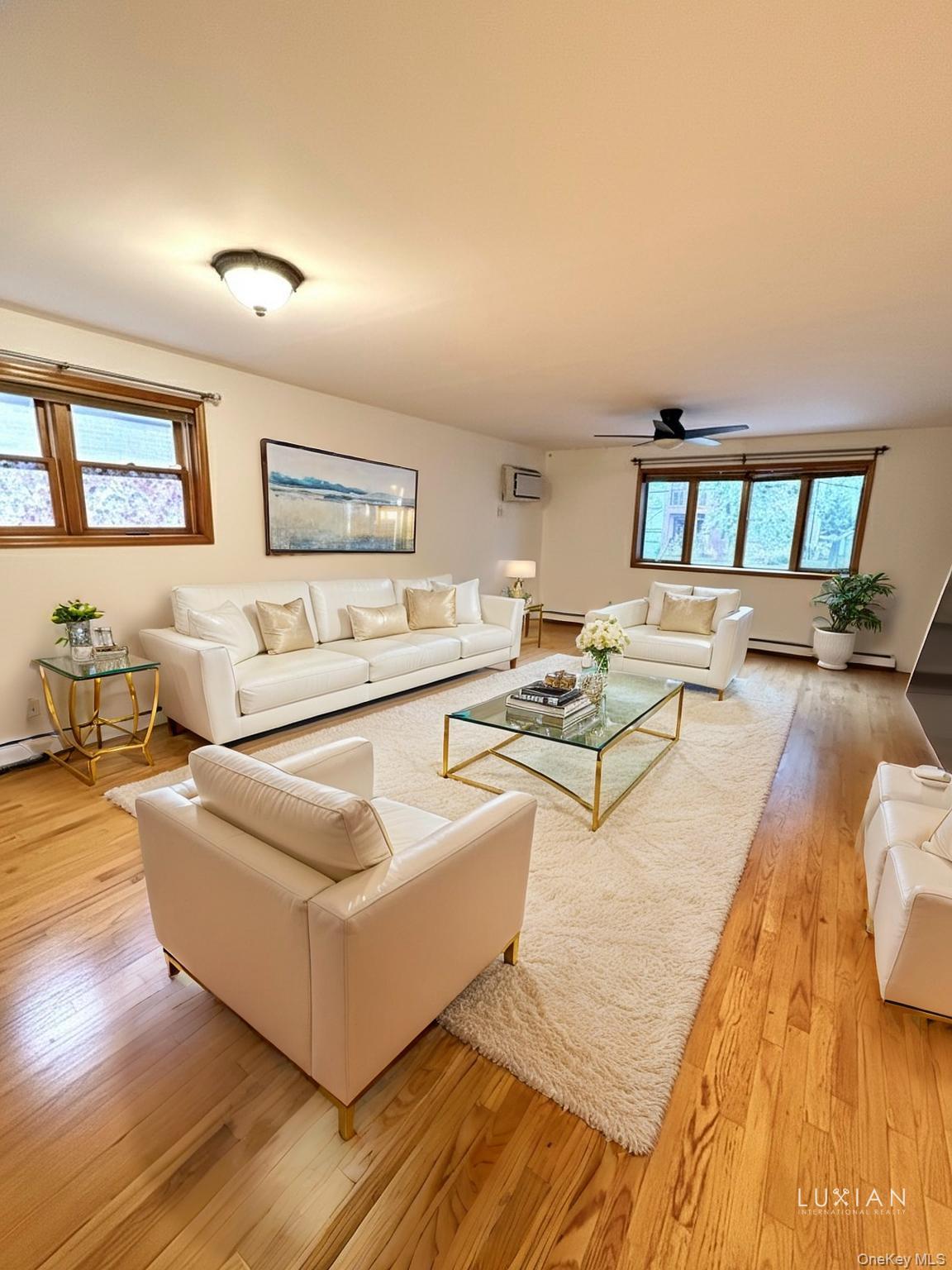 56-17 135th Street Queens, NY 11355 - Photo 1 of 8 a living room with furniture and a wooden floor
