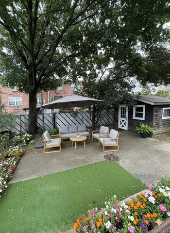 a view of a patio with table and chairs and potted plants