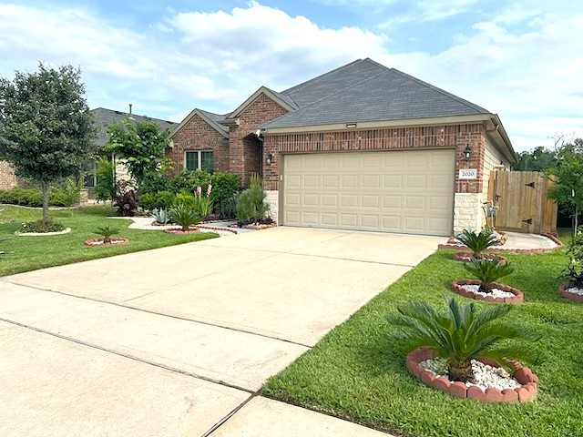 2020 Cedar Tree Court Conroe, TX 77301 - Photo 2 of 26 Stunning brick elevation w/stone accents. This home is very energy efficient with high-efficiency HVAC, insulated doors & insulated Low-E windows, batt insulation, blown fiberglass insulation, radiant attic barrier, ceiling fans & tankless/on-demand hot water heater