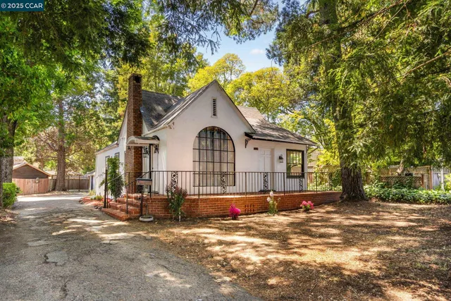 a view of a white house with a yard