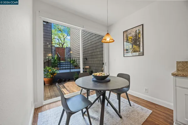 a kitchen with stainless steel appliances granite countertop a stove top oven a sink dishwasher and a refrigerator with wooden floor