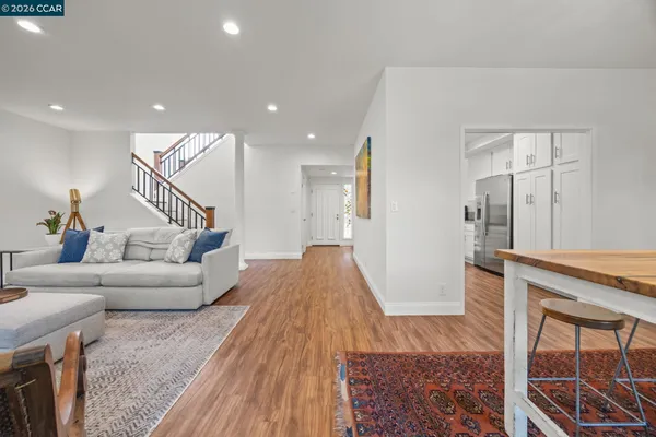a living room with furniture wooden floor and a fireplace