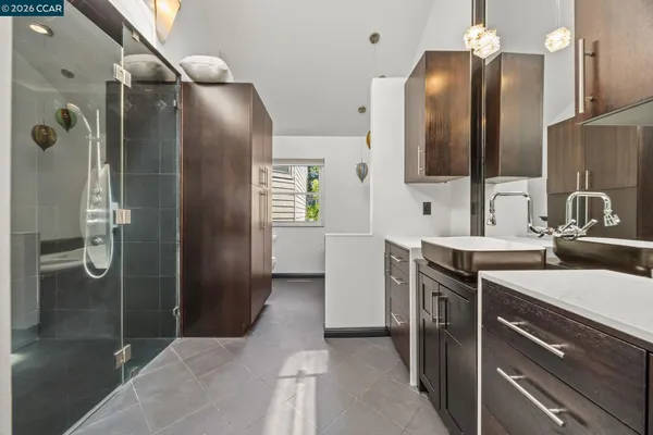 a bathroom with a sink a light fixture a vanity and a mirror
