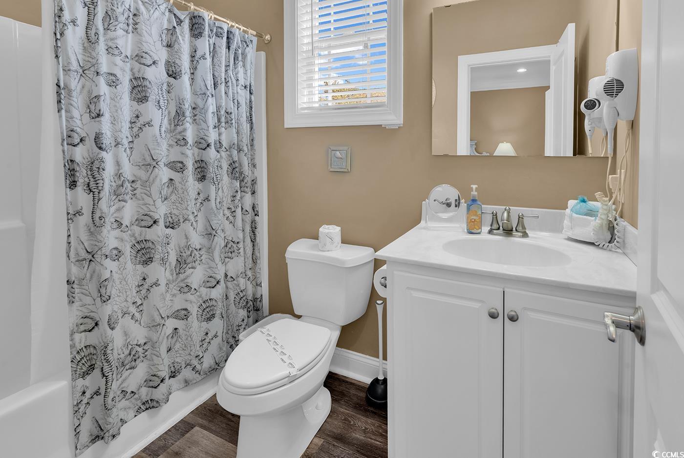 124 B Vista Drive Murrells Inlet, SC 29576 - Photo 17 of 38 Bathroom with vanity, dark wood-style flooring, and shower / tub combo