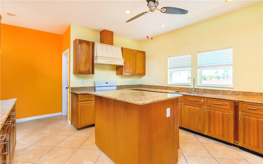 12277 Boat Shell Drive Matlacha Isles, FL 33991 - Photo 18 of 46 a kitchen with stainless steel appliances granite countertop a sink and a refrigerator