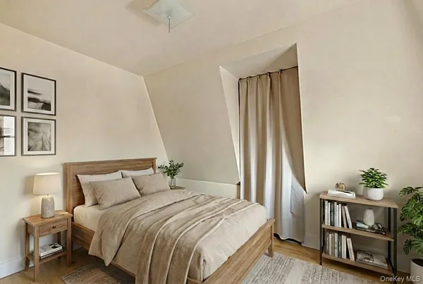 a bedroom with a bed a table and a painting