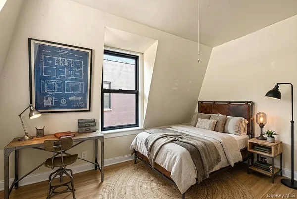 a bedroom with a bed and a window