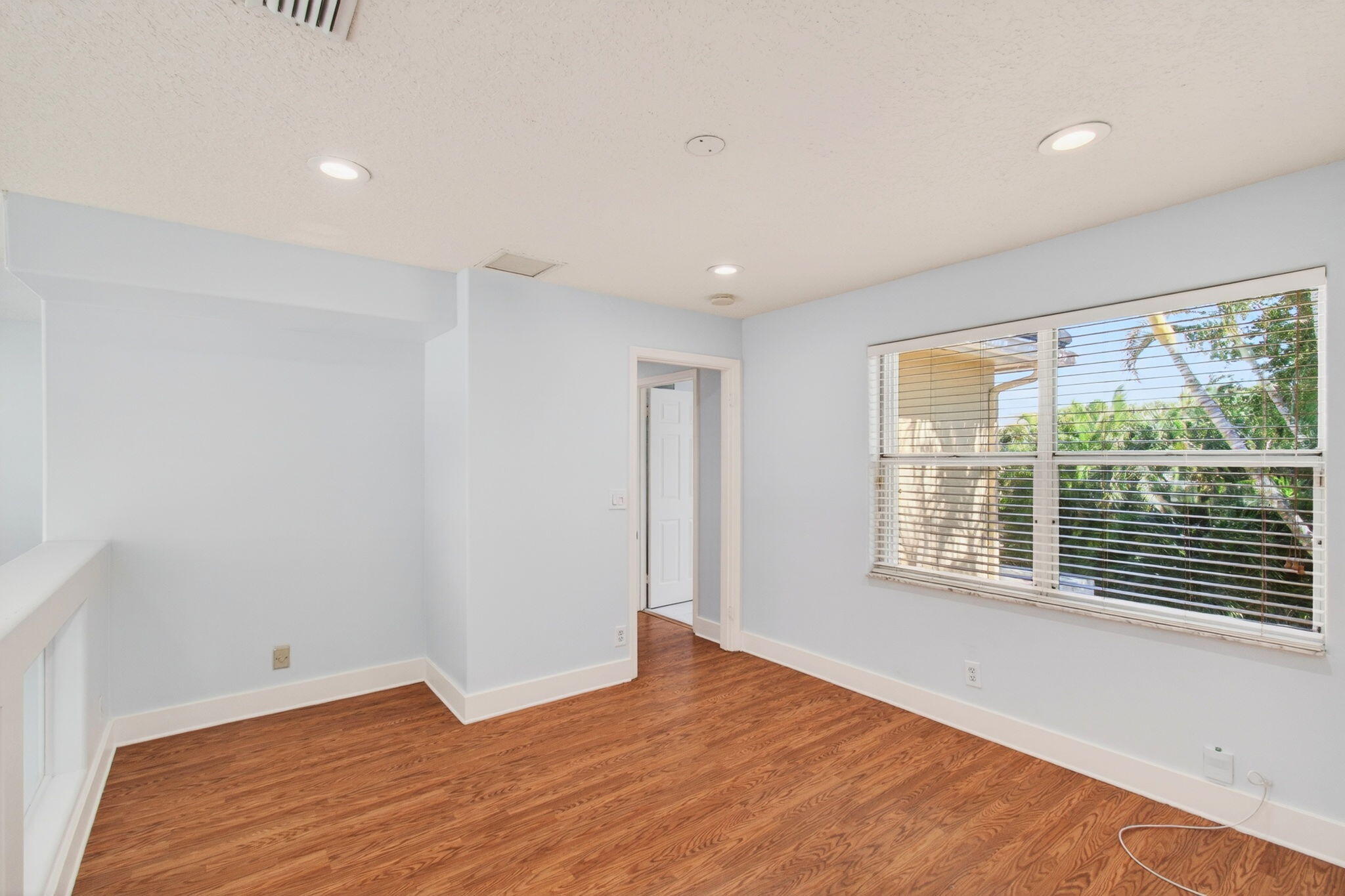 7848 Travelers Tree Drive Boca Raton, FL 33433 - Photo 35 of 60 a view of an empty room with wooden floor and a window