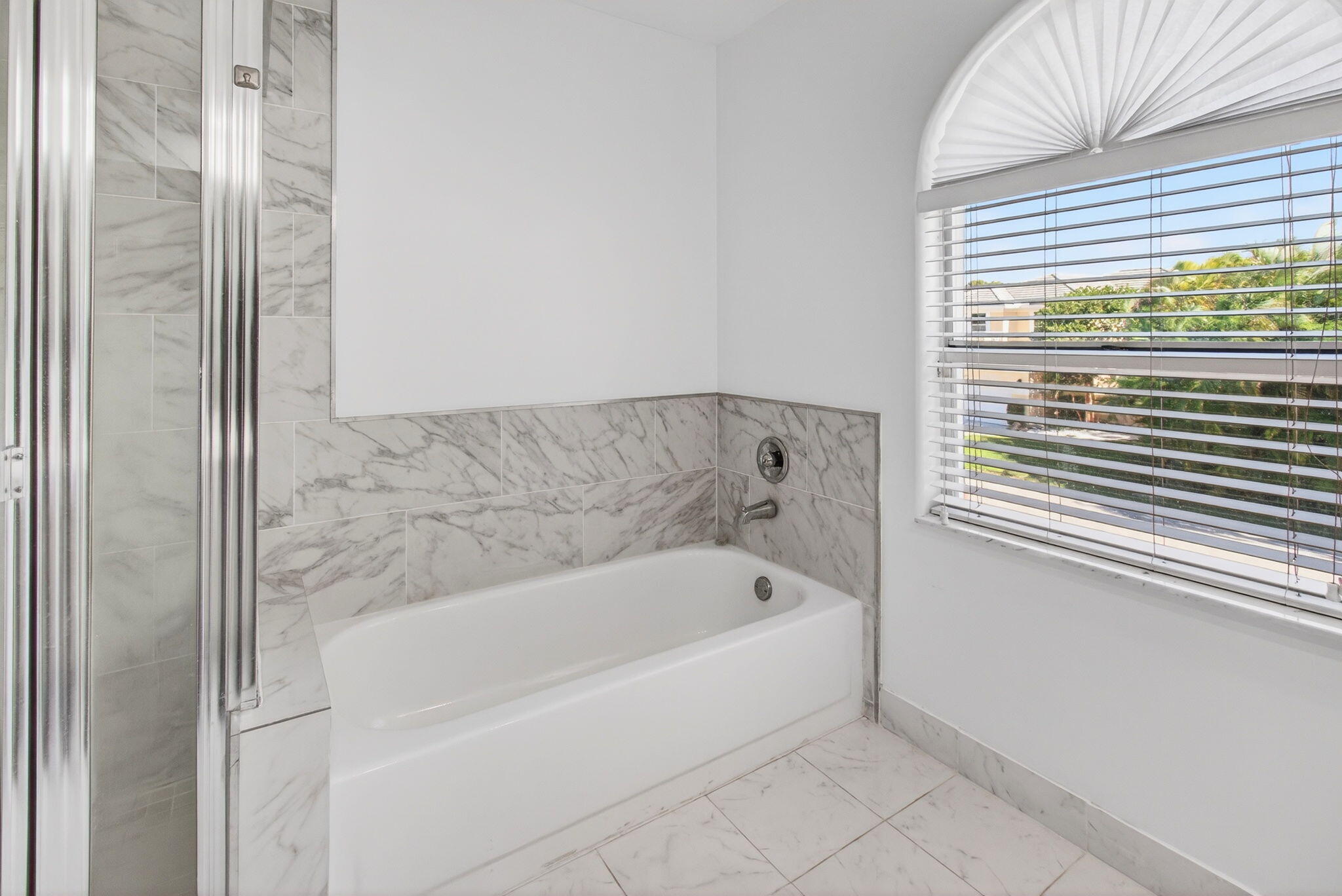 7848 Travelers Tree Drive Boca Raton, FL 33433 - Photo 37 of 60 a white bath tub sitting next to a window