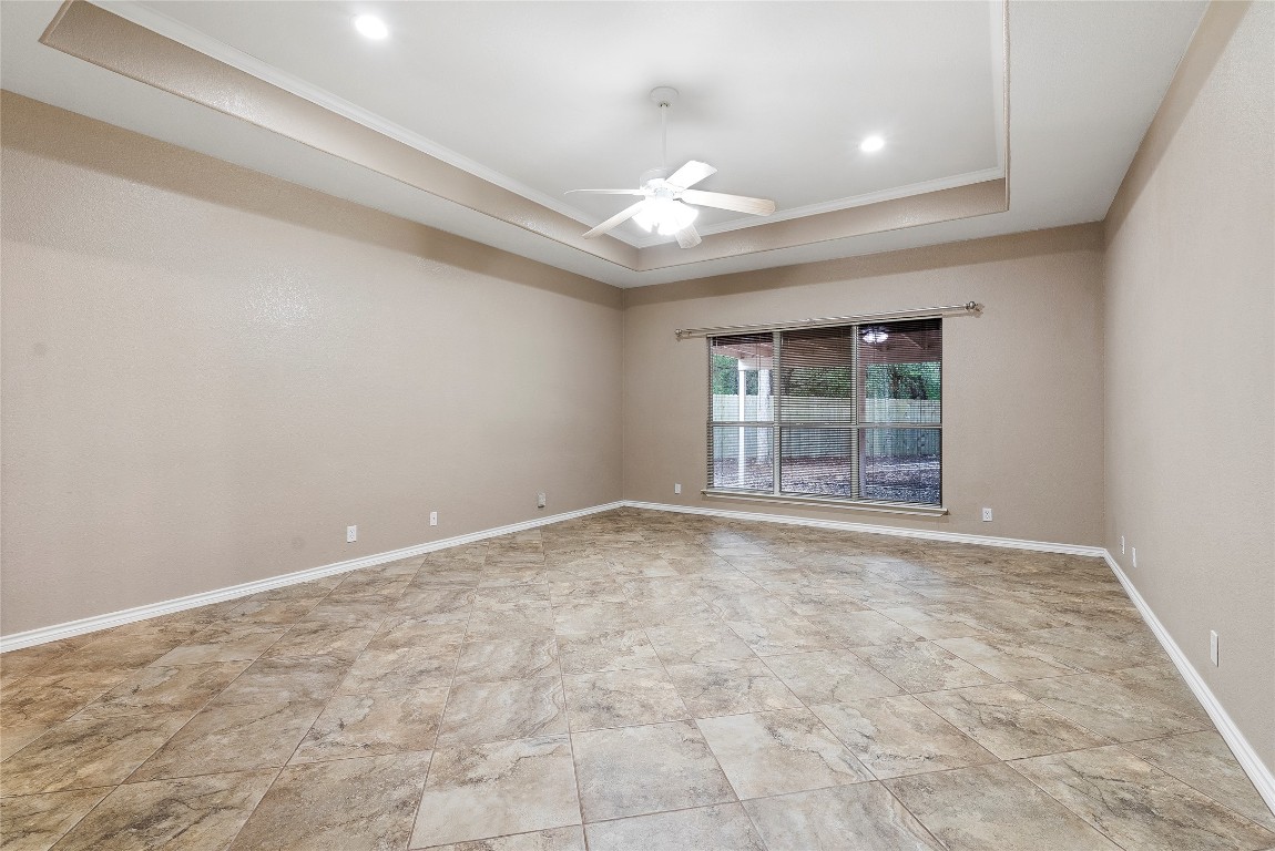 230 Cedar Hills Drive Elgin, TX 78621 - Photo 11 of 40 en empty room with windows and ceiling fan