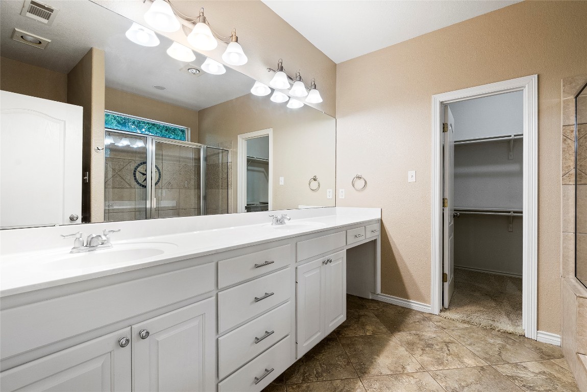 230 Cedar Hills Drive Elgin, TX 78621 - Photo 13 of 40 a bathroom with a double vanity sink and a mirror