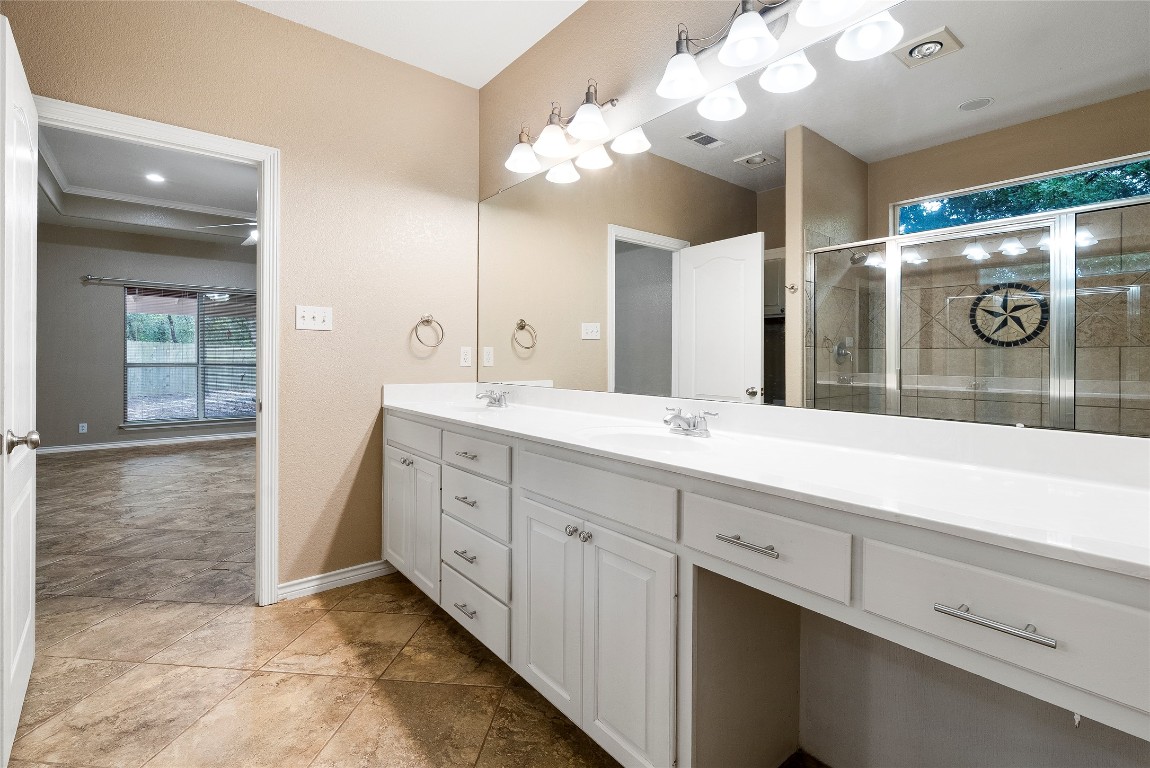 230 Cedar Hills Drive Elgin, TX 78621 - Photo 14 of 40 a spacious bathroom with a granite countertop sink a mirror and a shower
