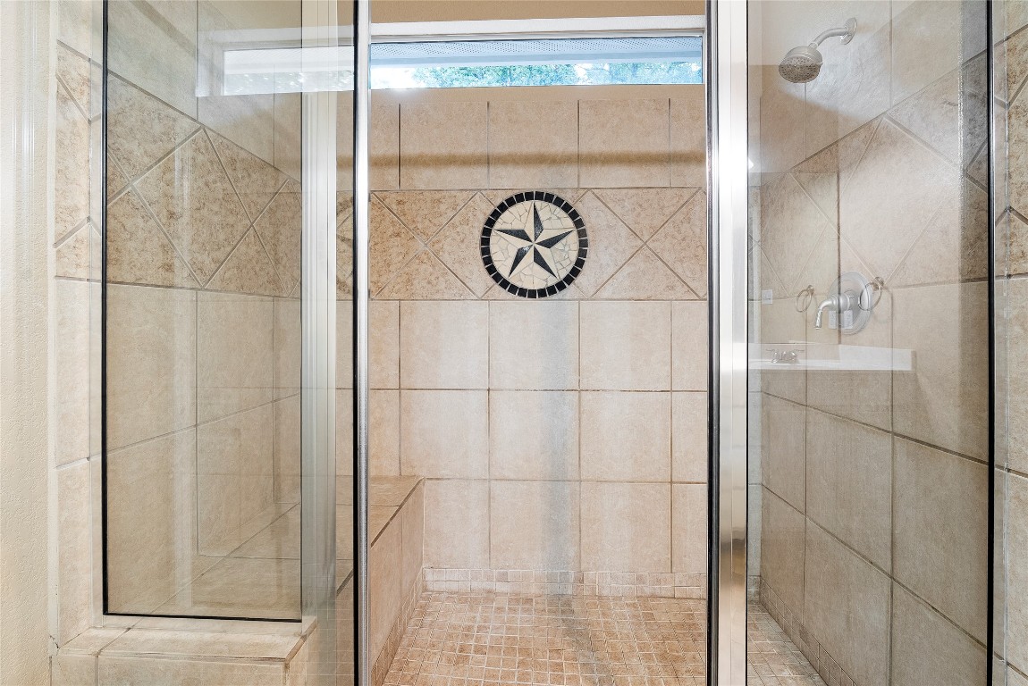 230 Cedar Hills Drive Elgin, TX 78621 - Photo 15 of 40 a bathroom with a shower and a mirror