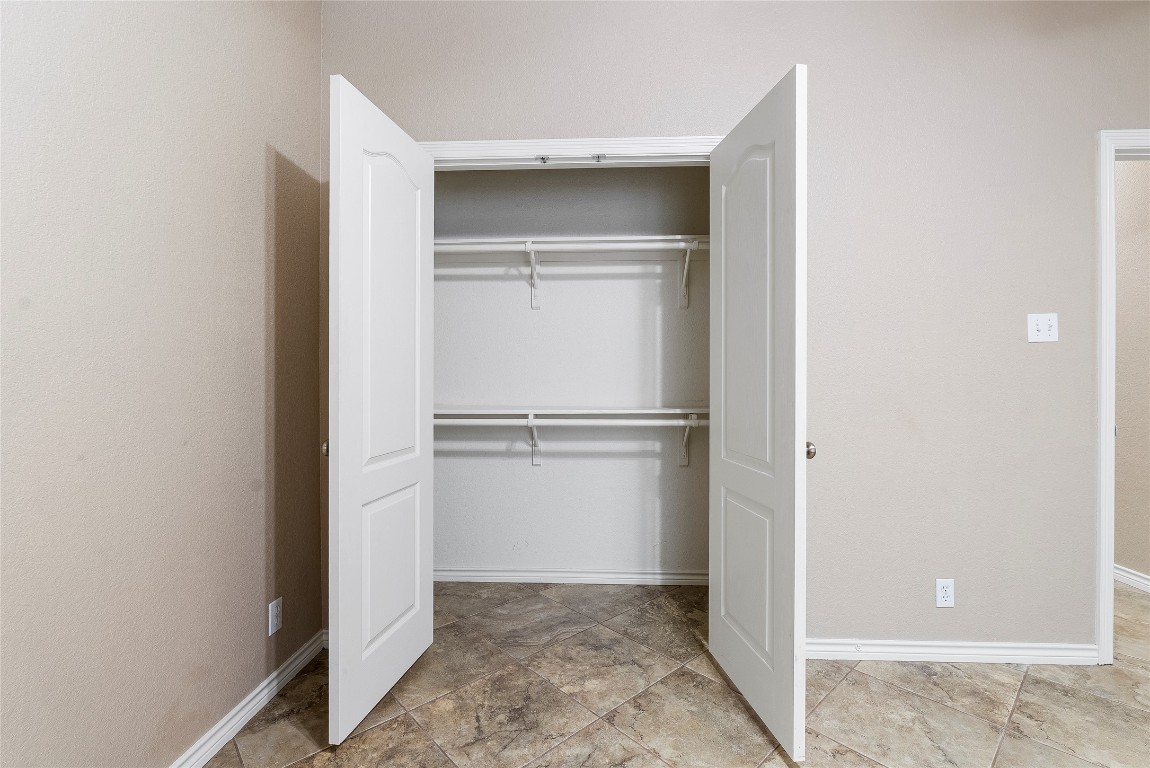 230 Cedar Hills Drive Elgin, TX 78621 - Photo 18 of 40 a view of walk in closet with empty racks